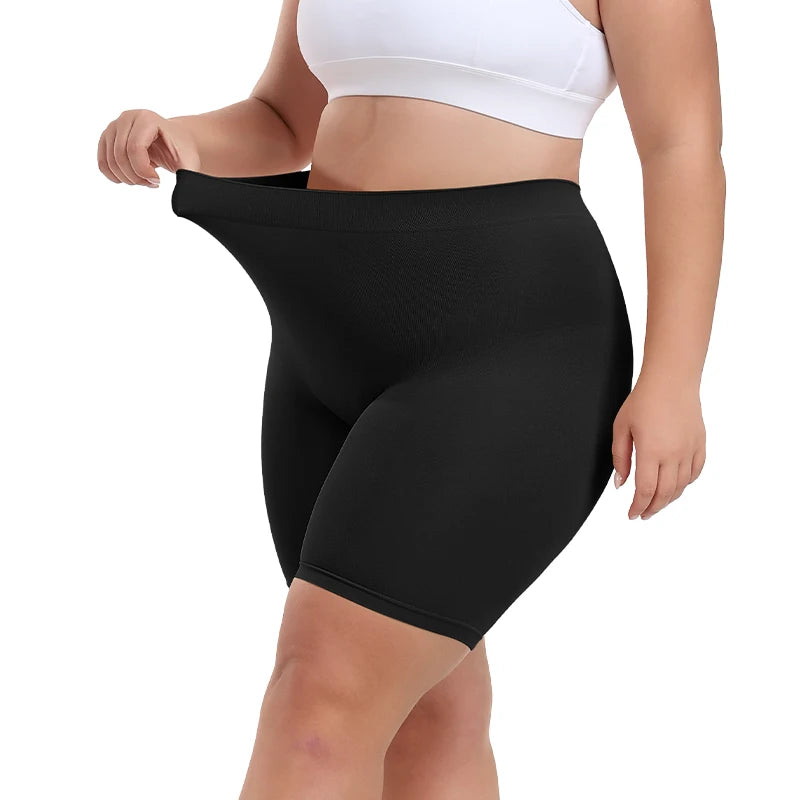 Person wearing black shapewear shorts on a white background