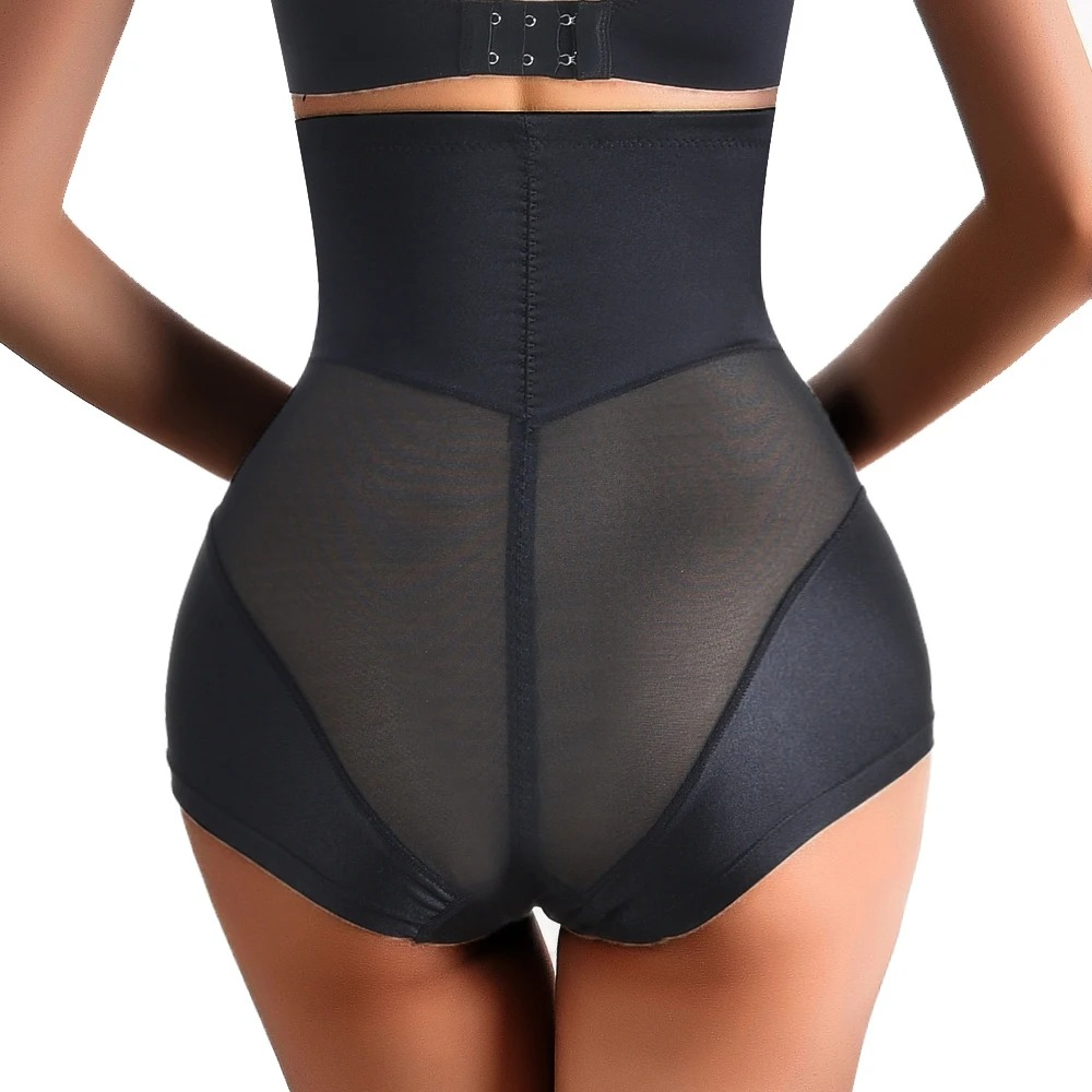 Black shapewear garment on a model against a white background