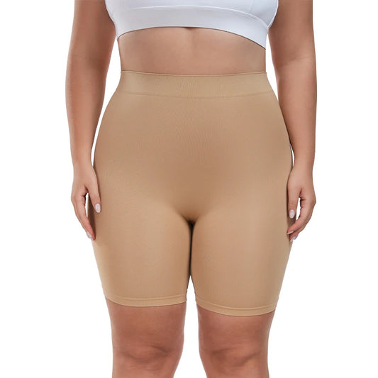 Person wearing beige shapewear shorts and a white sports bra on a white background