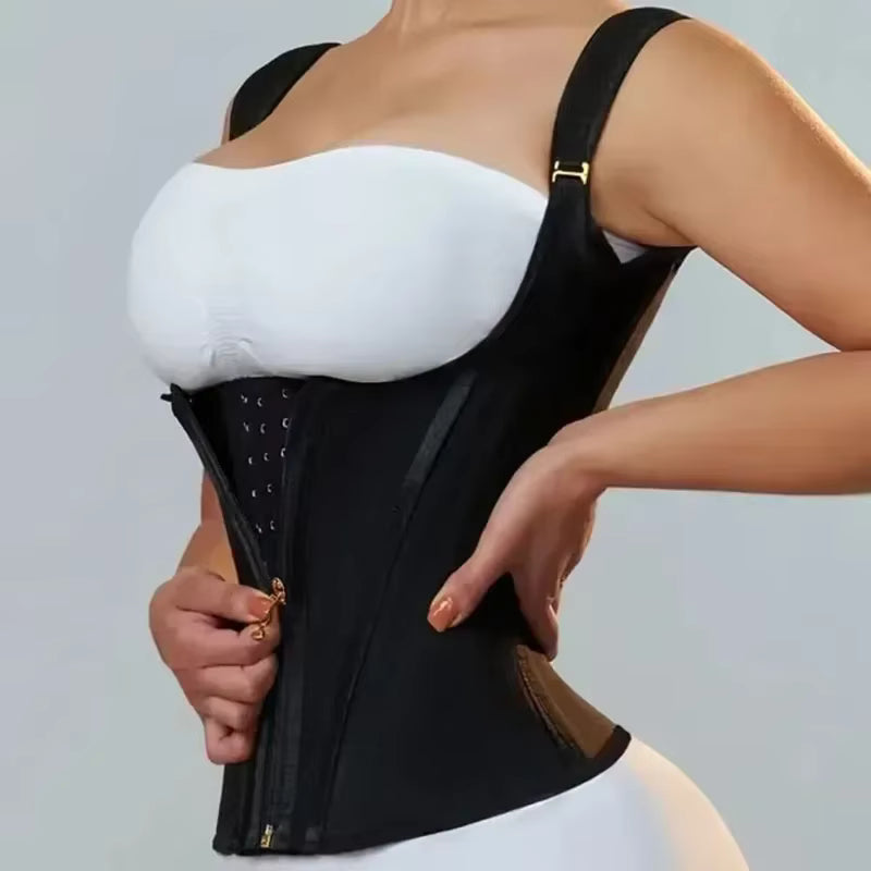 Person wearing a black waist trainer over a white bra on a gray background
