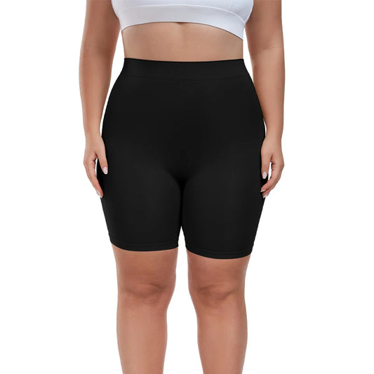 Person wearing black shapewear shorts on a white background