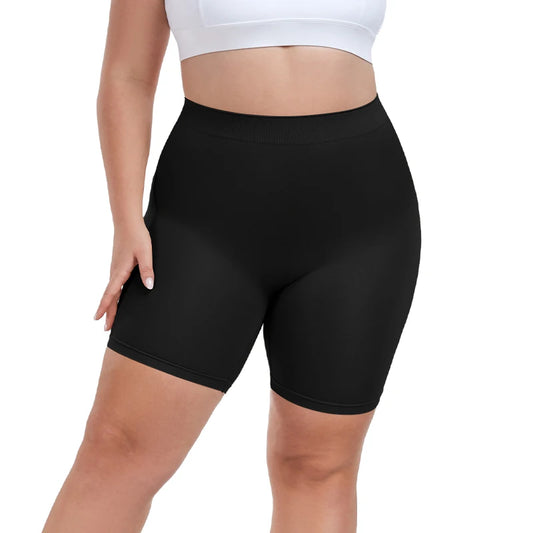 Person wearing black shapewear shorts on a white background