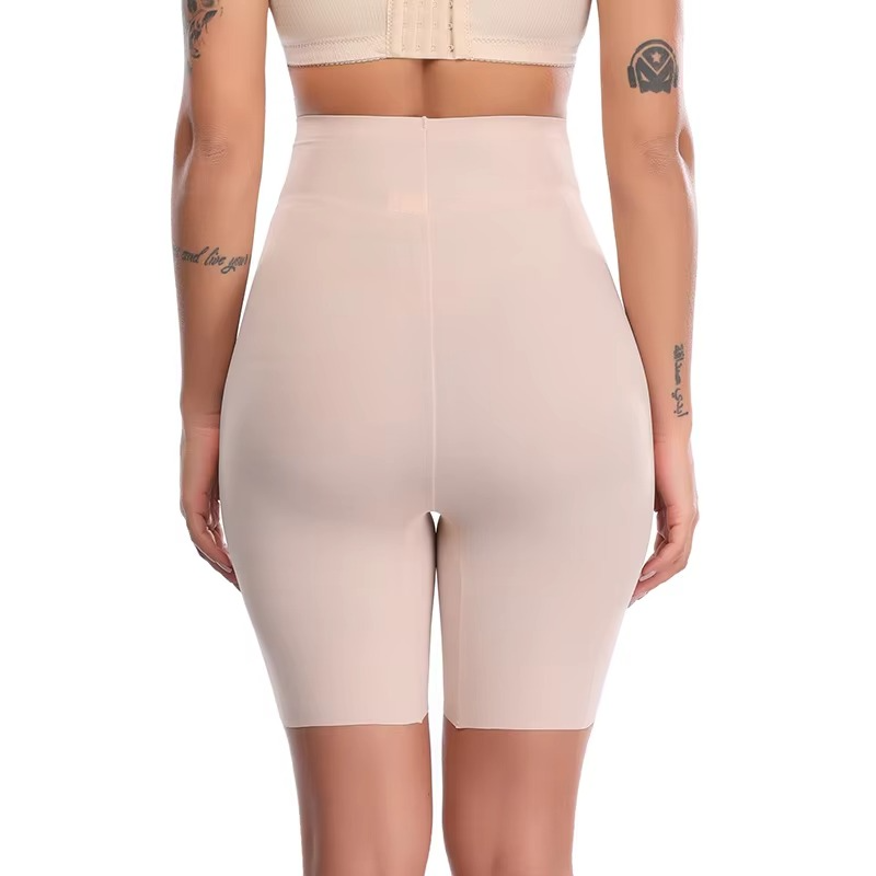 Beige shapewear shorts worn by a person on a white background
