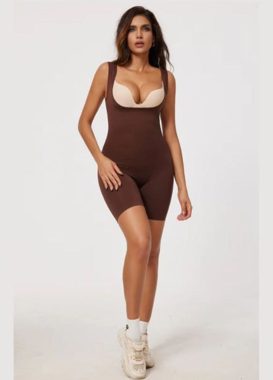 Woman wearing a brown bodysuit on a white background