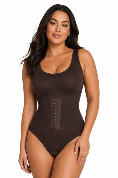 Woman wearing a brown bodysuit on a white background
